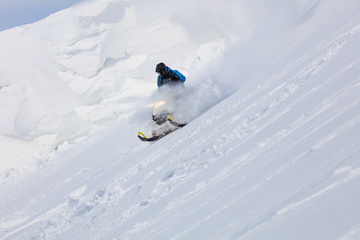 SHEREGESH-March 5, 2020: a professional rider rides and jumps on a sports snowmobile. elite...