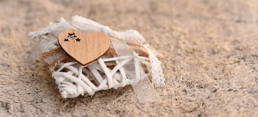 Wooden heart from a closer look on a textile background with copy space
