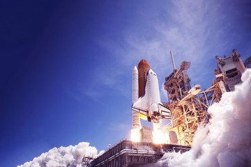 The launch of the space shuttle against the sky, fire and smoke. Elements of this image were...