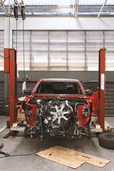 red car in automobile repair service center with soft-focus and over light in the background