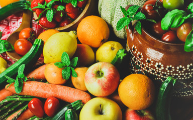 shapes and colors of fruit and vegetables arranged in a rustic composition