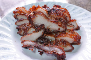 traditional Thai culture fried pork cuisine style or moo tod one of the most favorite famous street fast foods menu at thailand homemade
with hot spicy sauces on table wood dish sticky rice vegetable