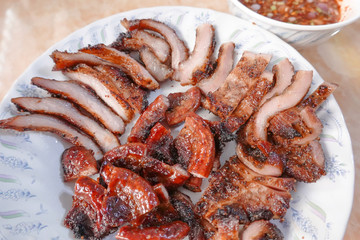 traditional Thai culture fried pork cuisine style or moo tod one of the most favorite famous street fast foods menu at thailand homemade
with hot spicy sauces on table wood dish sticky rice vegetable