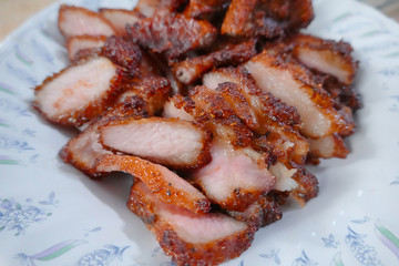 traditional Thai culture fried pork cuisine style or moo tod one of the most favorite famous street fast foods menu at thailand homemade
with hot spicy sauces on table wood dish sticky rice vegetable