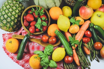 shapes and colors of fruit and vegetables arranged in a rustic composition