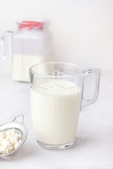Fermented milk drink kefir on a white background. Vertical photo. Healthy drinks for digestion