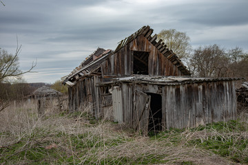 An old rickety abandoned house in an abandoned village is an illustration of abandonment and desolation.