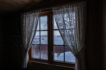 Fototapeta na wymiar Window view out of a hut in Lyngseidet, Norway