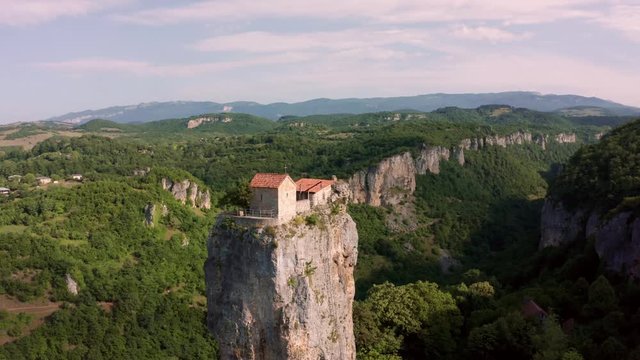 Katskhi pillar. Alone man's monastery near the village of Katskhi. The orthodox church and the abbot cell on a rocky cliff. Imereti, Georgia.