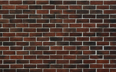 Red-brown brick wall with white seams