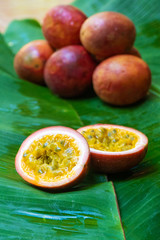 Ripe passion fruit, on a wet banana leaf. Vitamins, fruits, healthy foods