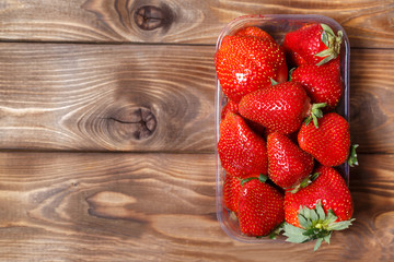Ripe strawberries in a plastic container