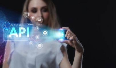 Business, Technology, Internet and network concept. Young businessman working on a virtual screen of the future and sees the inscription: API