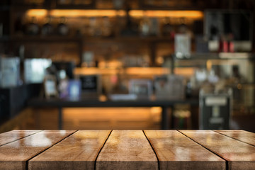 Empty old wood table top with bokeh coffee shop interior background.