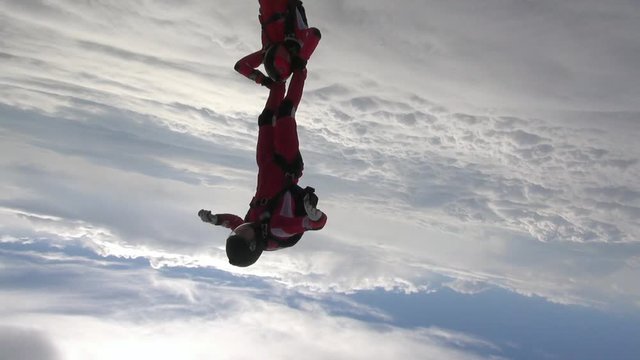 Two sports parachutist build a figure in free fall.