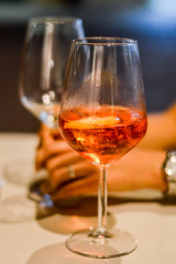 sharing spritz cocktails close up with hands - Spritz is a wine-based cocktail served as an aperitif in Italy. 