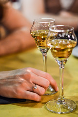 woman hand holding a glass of grappa close up