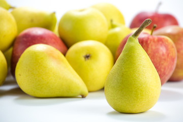 pears and apples on a white background. A lot of pears and apples on white