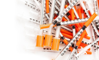 pile of syringes for diabetes on white background, healthcare concept.