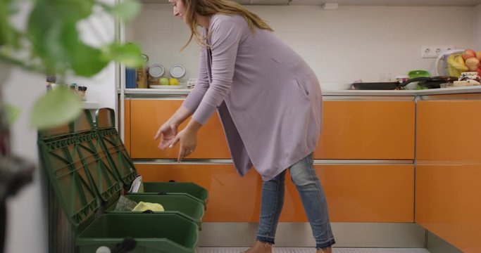 4K Slow Mo Of Woman Recycling And Taking Out The Trash From Kitchen