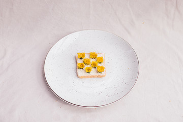 sandwich with dandelions on a plate