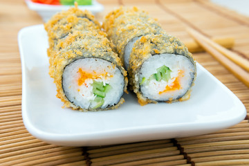 baked sushi rolls close-up. Unagi and flying fish ROE, futomaki ASI. Dish of Japanese cuisine
