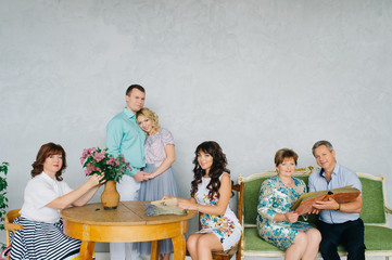 The festively dressed family stays at home together. A large group of people, a large family classic portrait in vintage interior.