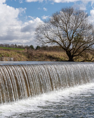 panorama landscape water flowing over a dam