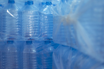 Bottling plant - Water bottling line for processing and bottling pure spring water into blue bottles. Selective focus.