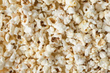 Popcorn grains close-up, close popcorn texture, popcorn on a yellow background