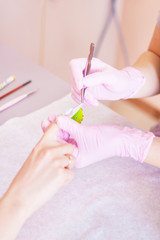 Obraz na płótnie Canvas Manicurist does nail care in a beauty salon.