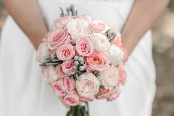 beautiful wedding bouquet in the hands of the bride. Wedding. Wedding decorations. Close-up