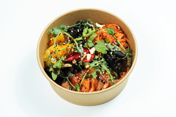 Hawaiian salmon fish poke bowl with rice, radish,cucumber, tomato, sesame seeds and seaweeds. Buddha bowl. Diet food