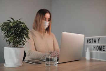 Portrait of One Beautiful Girl in White Medical Mask Working from Home