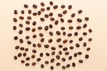 coffee beans scattered on a cream background