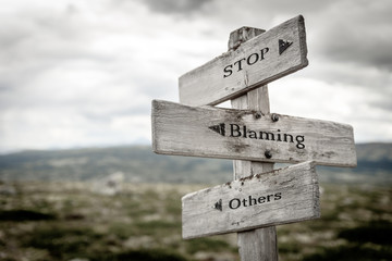 stop blaming others text engraved on old wooden signpost outdoors in nature. Quotes, words and...