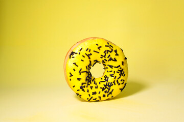 Striking bright yellow color on donuts with chocolate in the center, there is a place for text, a screen saver on your mobile phone