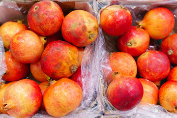 Fototapeta na wymiar pomegranates fruit in market. Fruits background. Texture selective focus