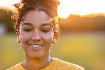 Beautiful Biracial Mixed Race African American Girl Smiling at Sunset - Powered by Adobe