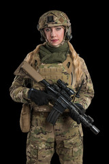 Female soldier in tactical black uniform with rifle. Shot in studio. Isolated with clipping path on...