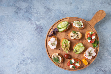 Delicious vegetarian bruschetta with tomatoes, avocado, mushrooms and herbs. Easy to cook, nutritious snack. Beautifully designed catering Banquet menu. Food snacks and snacks for the buffet.