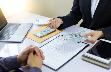 Businessmen give dollars to bribe employees in signing contracts to buy illegal land and real estate, Business fraud and social injustice, corruption and bribery concept.