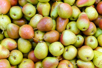 Fototapeta na wymiar organic yellow pear red background, on the shelves of the market