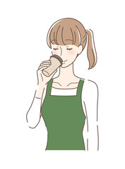 テイクアウトのコーヒーを飲む女性