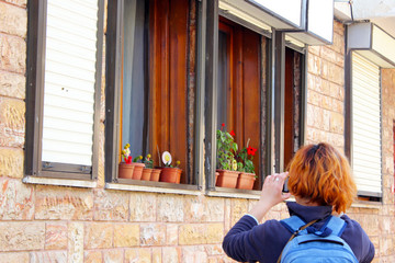women take photo of flower