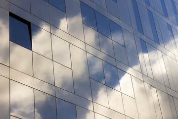 Fototapeta na wymiar Reflections of the sky on a glassy building