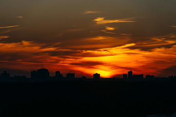 Fototapeta na wymiar Orange sunset over the city covered by clouds over Minsk, Belarus.