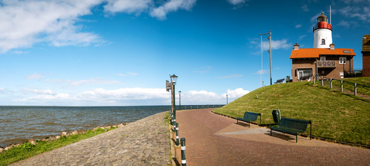 Urk Nehterlands, small fishing village Urk with is colorful lighthouse by the lake Ijsselmeer Netherlands Flevoland - obrazy, fototapety, plakaty