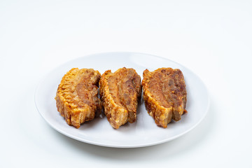 Deep Fried Crispy Streaky Pork Belly Thai and Chinese Food on White Plate on White Background Isolated.