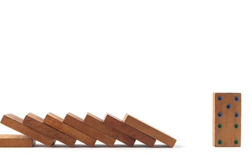 Social distancing concept wood domino toys on white background, . Domino effect. 8 dominos is falling and next one domino can stand.
